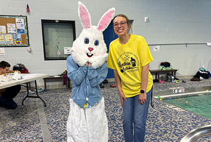 a student and a person dressed up in a bunny costume